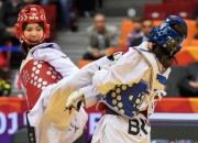 A final match is underway between Thailand's Panipak Wongpattanakit (in red uniforms) and Ukraine's Iryna Romoldanova in the women's -46kg category on the second day of the 2015 WTF World Taekwondo Championships at the Traktor Arena in Chelyabinsk, Russia on May 13, 2015. The Thai won the gold medal, while Chinese Taipei's Wan-Ting Lin and Brazil's Iris Tang Sing took the bronze medal in the division.